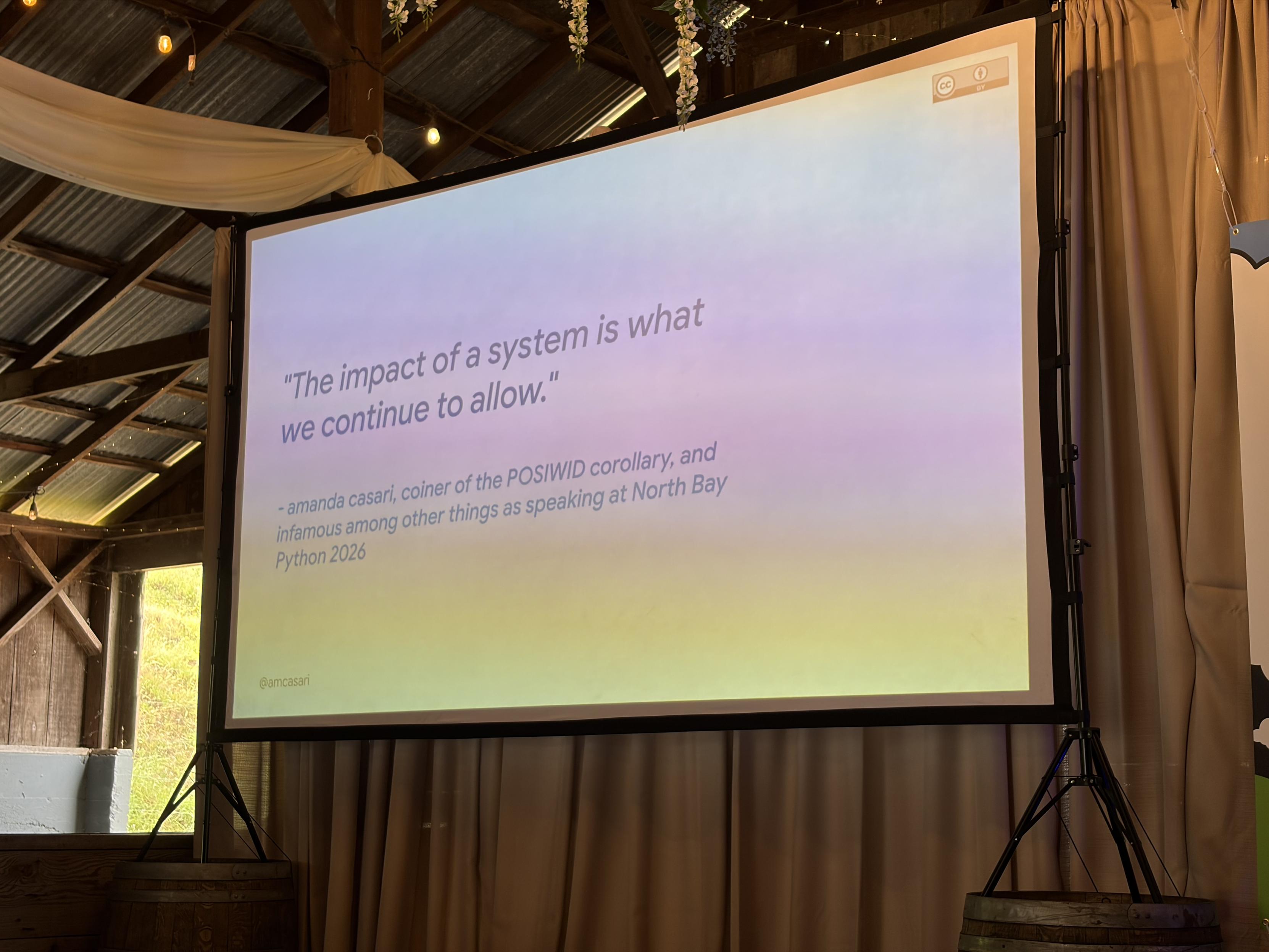 Picture of a slide that says “The impact of a system is what we continue to allow”, a corollary to “the purpose of a system is what it does”.